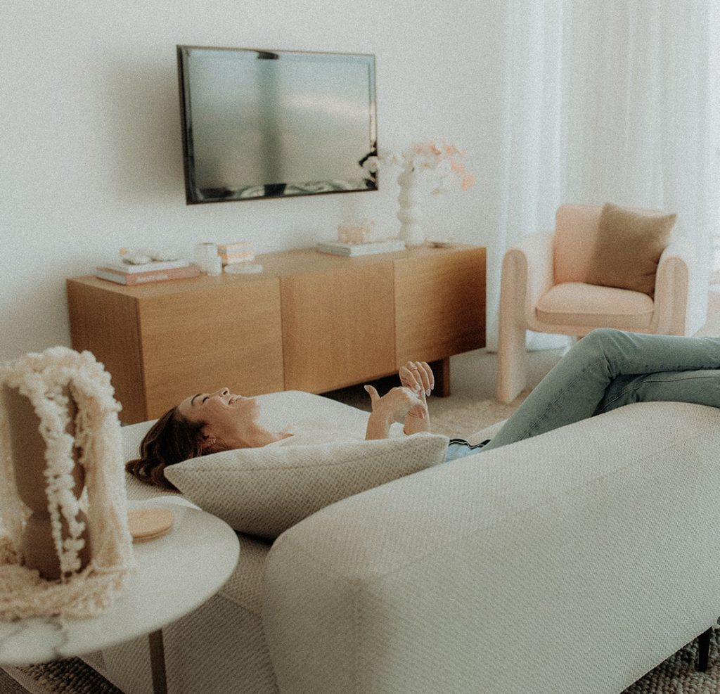 Bella laying on couch laughing sunshine streaming in